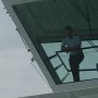 one of the officers looking down at all the sands being stirred up by the rudders