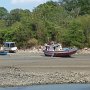 the boats are beached at low tide they have to wait until high tide to get out.