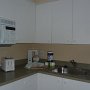 kitchen there is a 2 round hot plate in the cupboard